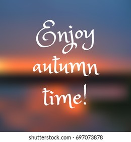 Inspirational quote on blurred background. Enjoy autumn time! Vector illustration.