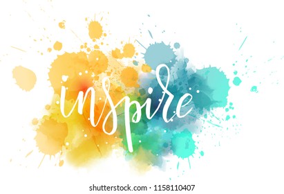 Inspire hand lettering phrase on watercolor imitation color splash.  Modern calligraphy inspirational quote. Vector illustration.