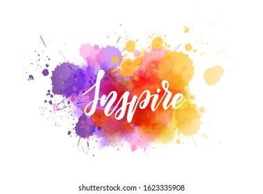 Inspire - motivational message. Handwritten modern calligraphy inspirational text on multicolored watercolor paint splash.