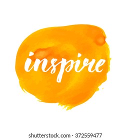 Inspire word handwritten on bright orange paint stain
