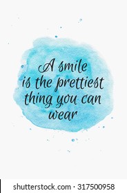 Inspiring quote about smile on watercolor blue background. Hand drawn lettering, calligraphy.