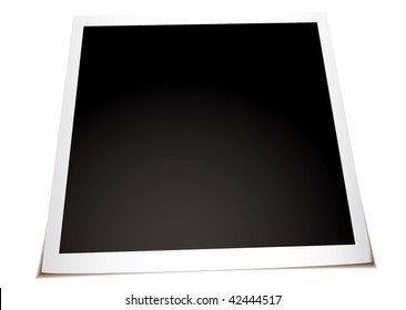 Instant photograph with shadow laying on a flat surface