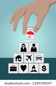 Insurance Coverage Concept. Hand Holding Wooden Blocks With Umbrella And Other Icons.