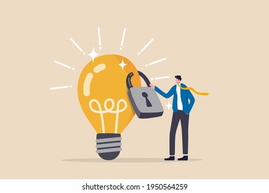 Intellectual property, patented protection, copyright reserved or product trademark that cannot copy concept, businessman owner standing with light bulb idea locked with padlock for patents.