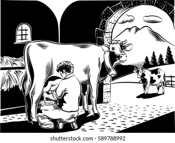 intent farmer milking a cow in the barn