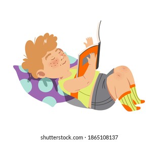 Interested Boy Character Lying on Pillow with Open Book and Reading Vector Illustration