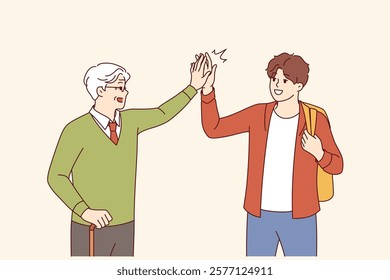 Intergenerational friendship between teenager and old man high-fiving each other as sign of solidarity. Intergenerational friendship between gray-haired grandfather with crutch and grandson