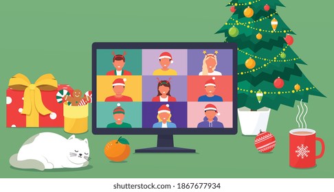 Interior of Christmas and New Years home workplace with christmas tree and decorations, gift, cane cookies and sweets, coffee, cat, laptop. Colleagues talk to each other on a laptop screen.
