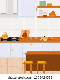 The interior of a modern kitchen with an extractor hood, stove, countertop. There is a kettle and a pan of pasta on the stove. Kitchen utensils.