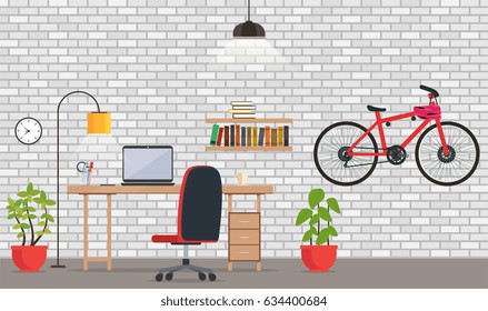 Interior of office or room with white brick wall. Modern room for work and leisure with a table, a laptop, chair, lamp lighting, shelf with books, bicycles.