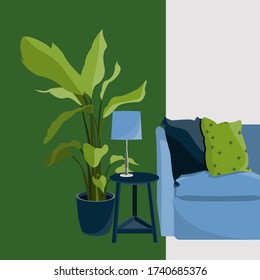 The interior of the room.A blue scandi style sofa with bright pillows, a small round coffee table on three legs, a lamp standing on the table. A large flower pot with a palm plant with large leaves