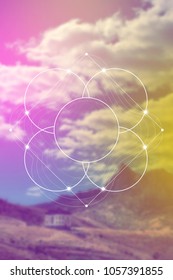 Interlocking circles flower of life sacred geometry illustration with golden ratio digits in front of photographic background.
