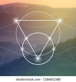 Interlocking circles, triangles and squares hipster sacred geometry illustration with light dots in front of photographic background.