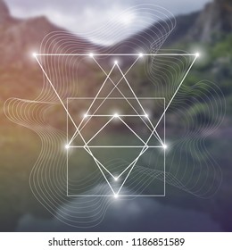 Interlocking circles, triangles and squares hipster sacred geometry illustration with light dots in front of photographic background.