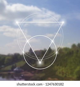 Interlocking circles, triangles and squares hipster sacred geometry illustration with light dots in front of photographic background.