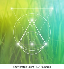 Interlocking circles, triangles and squares hipster sacred geometry illustration with light dots in front of photographic background.