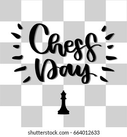International  Chess Day. Words are written by hand with a brush. Against the background of a chessboard.