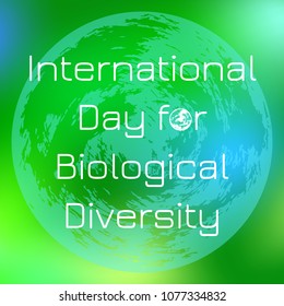 International Day for Biological Diversity. The concept of ecological holiday. Planet Earth. On a green blurred background. Event name