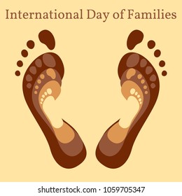 International Day of Families. Concept of a family of 4 people - father, mother, daughter, baby - their footprints on each other