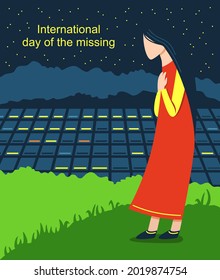 International day of the missing. A sad girl stands on a hill, looking with hope at the night city. Loss of a loved one.