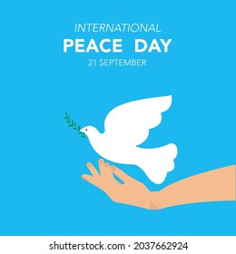 International Day of Peace. The pigeon flies out of his hand. Symbol of peace. Vector in flat design