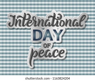  International Day of Peace text isolated  on checkered background. Hand sketched lettering with light outline. World Peace Day template for greeting cards, posters, banners. Vector typographic design