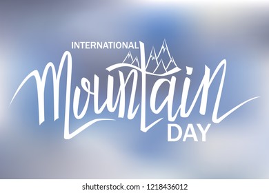 International Mountain Day. Vector illustration with hand drawn lettering on blurred background.