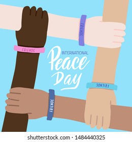 International Peace day greeting card with brush letterng quote. Four hands of people of different races and nationalities crossed together on blue background. Vector illustration of world friendship