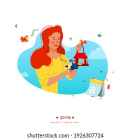 International Women's Day. A celebration of spring. A girl holds a bird feeder. The birds are singing. A kind woman takes care of the birds. Nature comes alive.