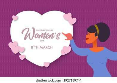 International Women's Day March 8th, Woman pointing to text in white heart.