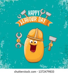 International workers day or labour day greeting card . vector funny cartoon brown smiling worker potato with engineer helmet holding hammer and wrench isolated on grunge background. Mayday poster