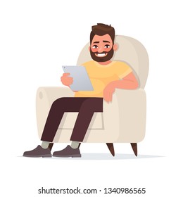 Internet addiction. A waste of time on social networks. A man holds a tablet sitting on the couch. Vector illustration in cartoon style