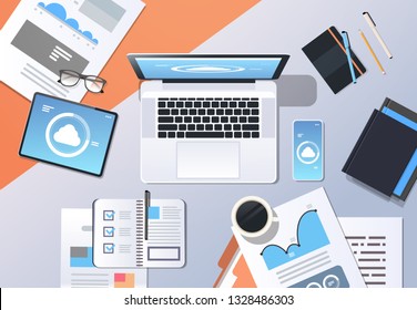 internet connection cloud synchronization tablet smartphone laptop screen network data sync concept top angle view workplace desktop office stuff horizontal