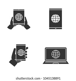 Internet connection glyph icons set. Hand holding tablet pc, smartphone and laptop with globe. Silhouette symbols. Vector isolated illustration
