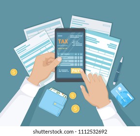 Internet Payment Of Taxes, Invoice, Bill, Banking. Man Hand Holding The Phone And Presses The Pay Button. Online Paying, Financial Accounting. Documents, Forms, Money, Wallet, Credit Card On The Table