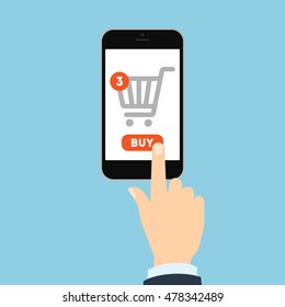 Internet shopping concept. Hand pulling buy button on smartphone. Three items in shopping cart. E-commerce concept. Shopping online.