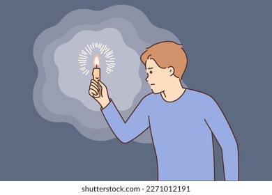 Intrigued man carries burning candle, illuminating path in darkness, hearing rustle or suspicious sound. Guy with candle with wary look moves around dark room after electricity or blackout 