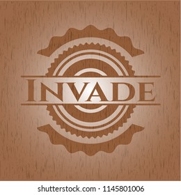 Invade badge with wood background