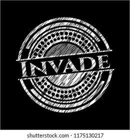Invade written with chalkboard texture