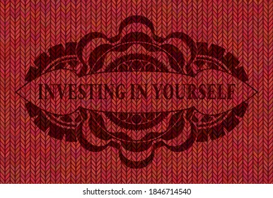 Investing in yourself text inside Red wool realistic badge. Cloth luxurious background. Vector illustration. 