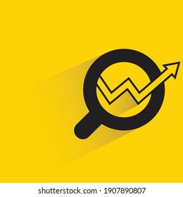 investment stock market chart and magnifier glass  shadow on yellow background