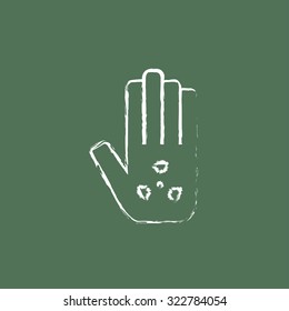 Ionizing radiation sign on a palm hand drawn in chalk on a blackboard vector white icon isolated on a green background.
