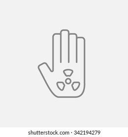 Ionizing radiation sign on a palm line icon for web, mobile and infographics. Vector dark grey icon isolated on light grey background.