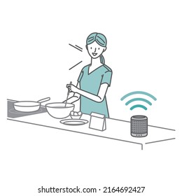 IoT related: A woman talking to a smart speaker while cooking in the kitchen