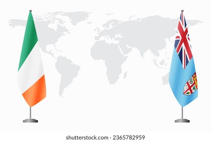 Ireland and Fiji flags for official meeting against background of world map.