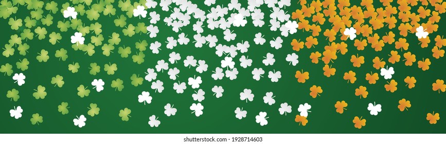 Irish flag with falling green white orange clovers Happy St Patricks Day background banner