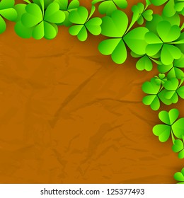 Irish four leaf lucky clovers on grungy brown background for Happy St. Patrick's Day. EPS 10.