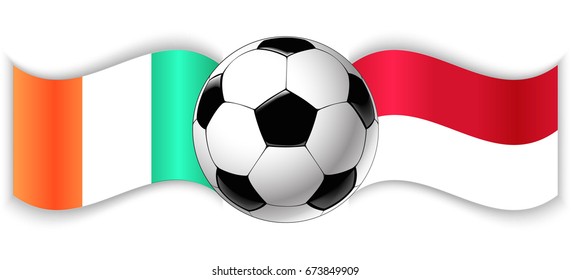 Irish and Indonesian wavy flags with football ball. Ireland combined with Indonesia isolated on white. Football match or international sport competition concept.