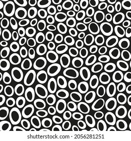 Irregular circles all over print on black background. Random placed, vector retro dots.