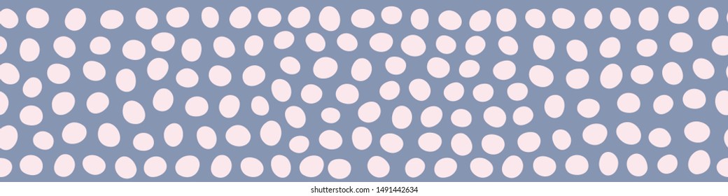 Irregular polka dot border seamless pattern in blue and pink. A vector repeat design background.